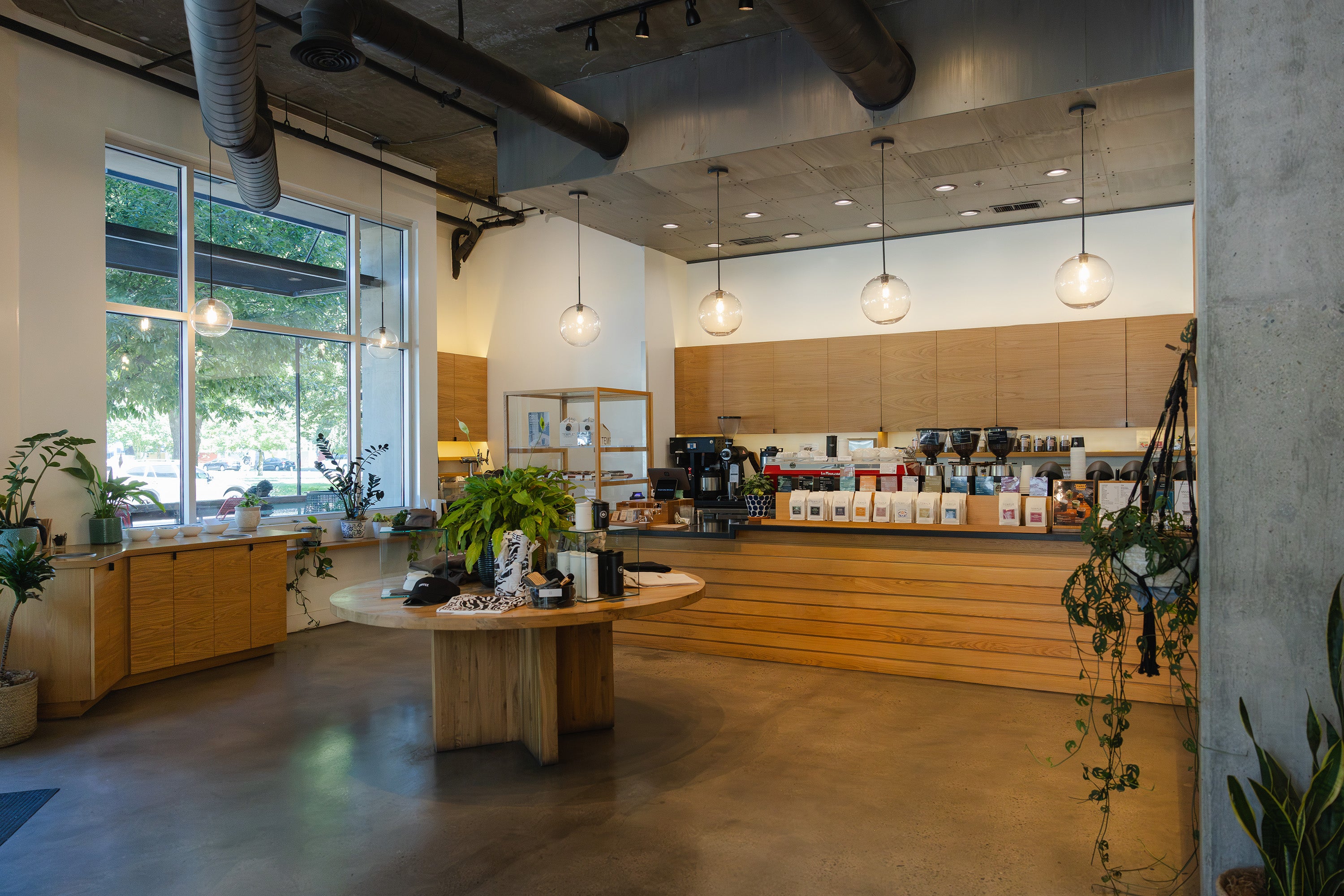 Modern coffee shop interior with counter and seating area.