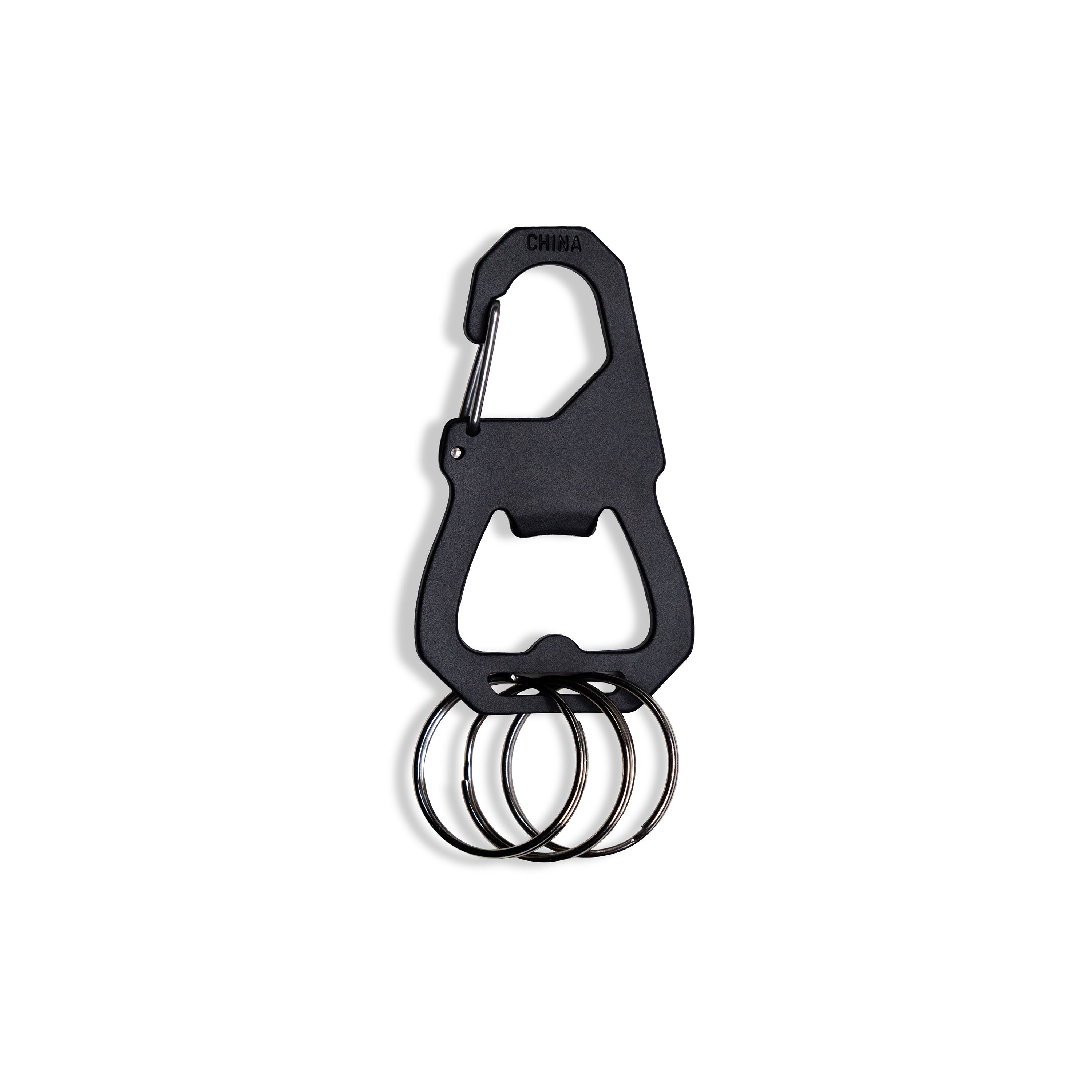 A black carabiner-style bottle opener keychain with four attached metal key rings, shown on a plain white background.
