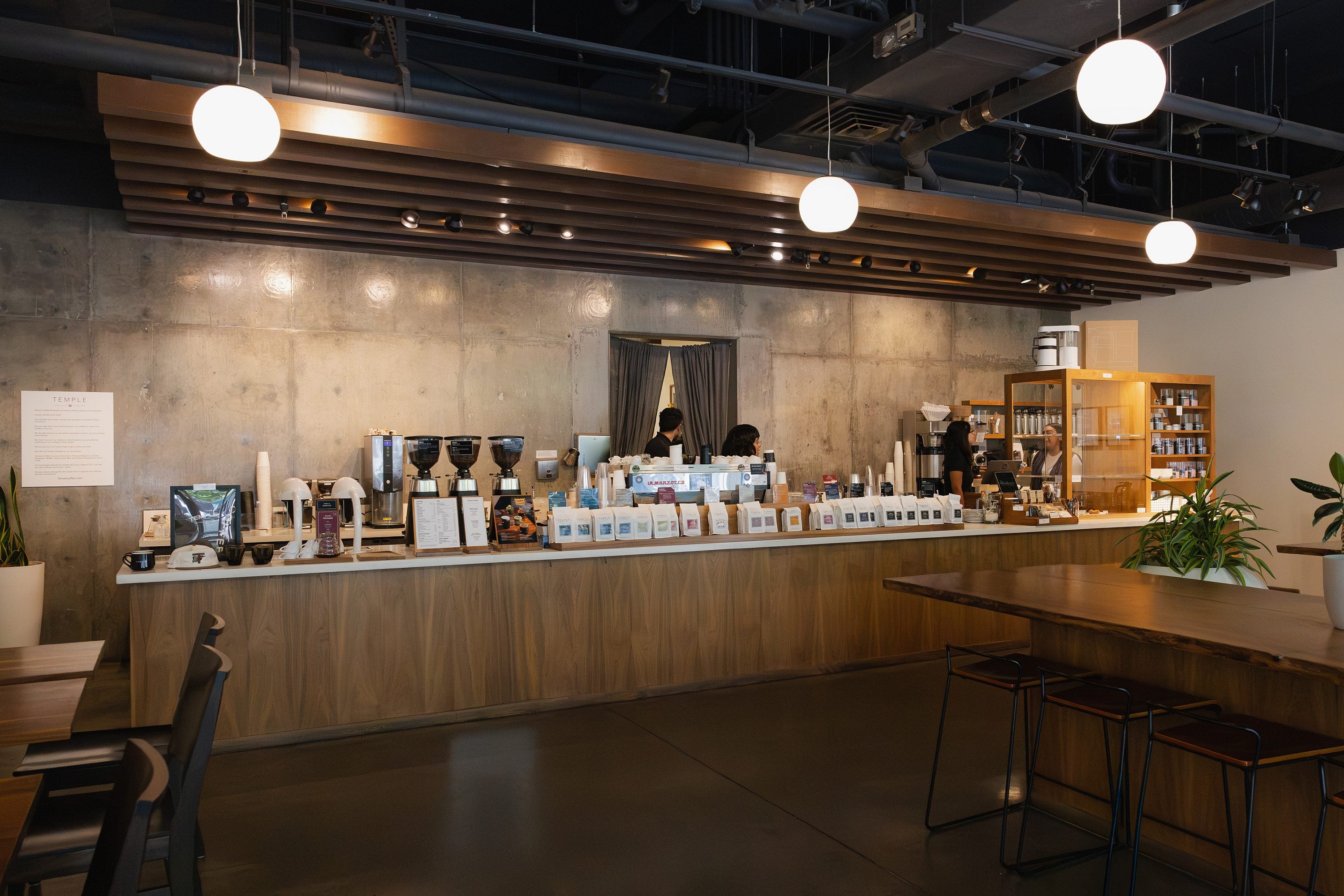 Modern coffee shop interior with counter and seating area.
