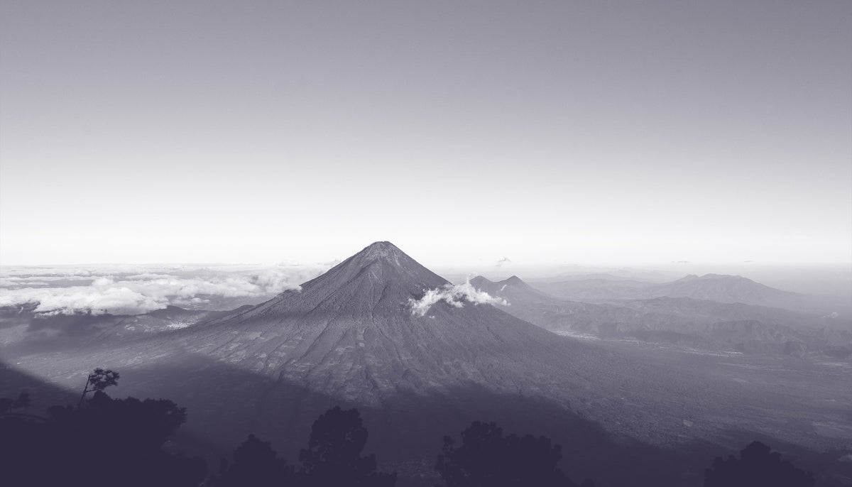 Black and white mountain landscape with a prominent peak.