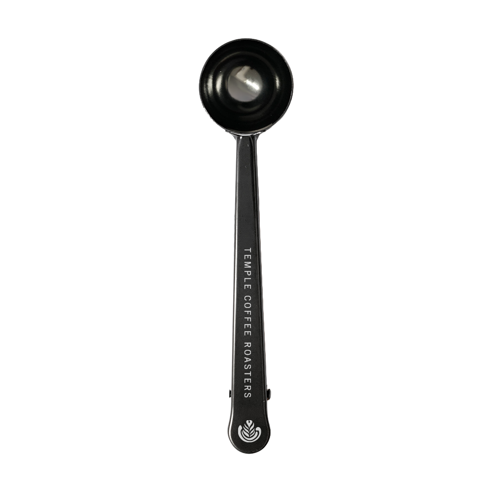 Bronze coffee scoop with 'Temple Coffee Roasters' branding 