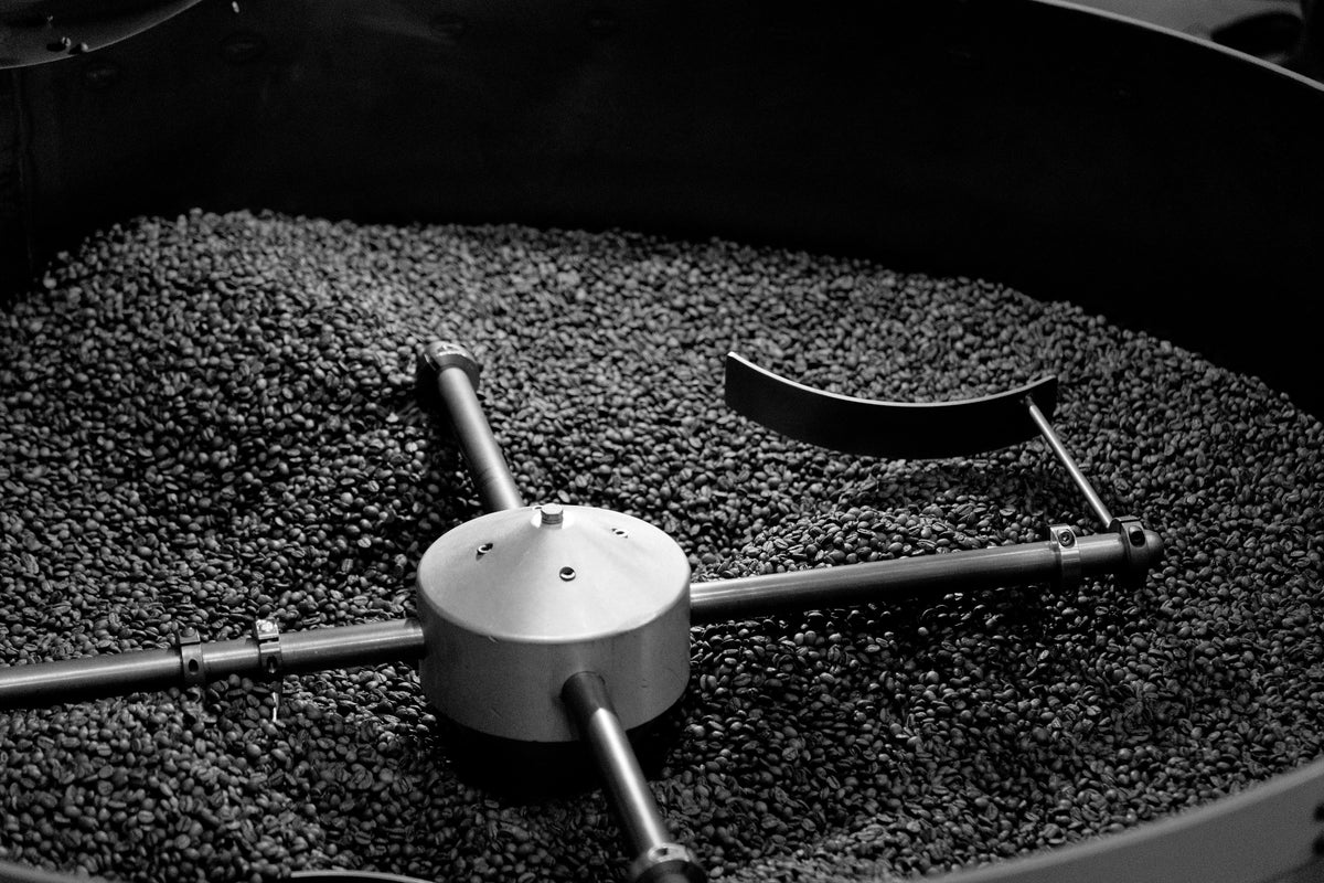 Coffee beans being processed in a roaster