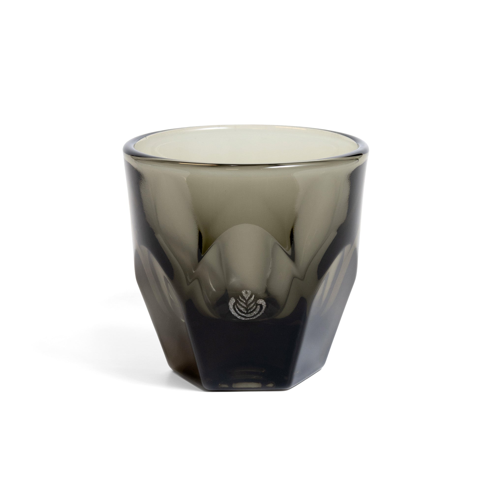A smoke-colored angular glass with interior curvature, featuring rosetta engraving on one side.