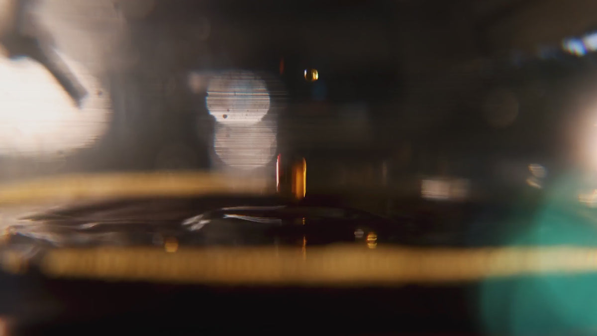 Close up footage of dripping, water pouring, a glass is filled with cold brew, a kettle pouts over an orgami dripper.