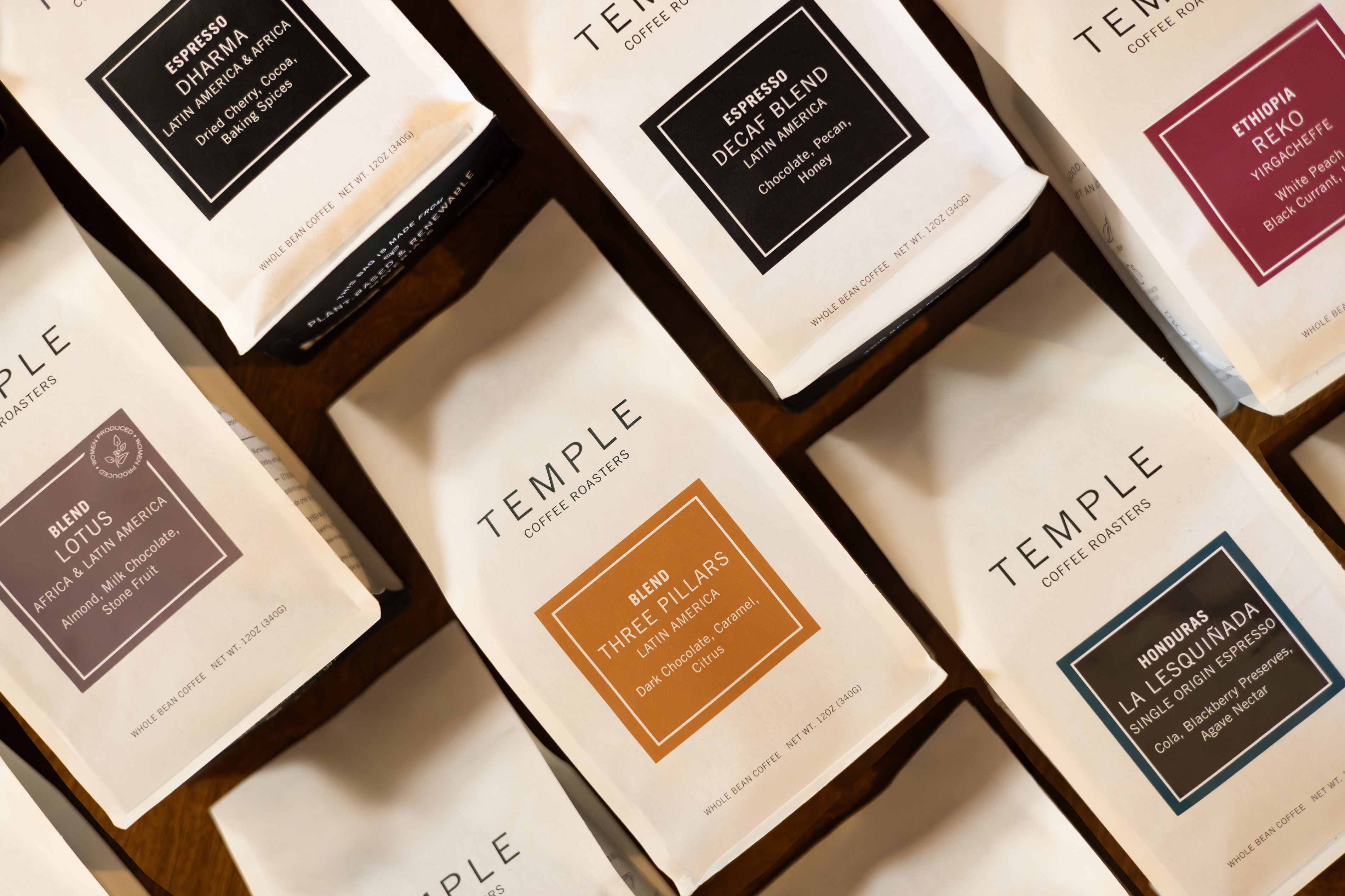 Collection of Temple Coffee Roasters coffee bags with various names and designs.