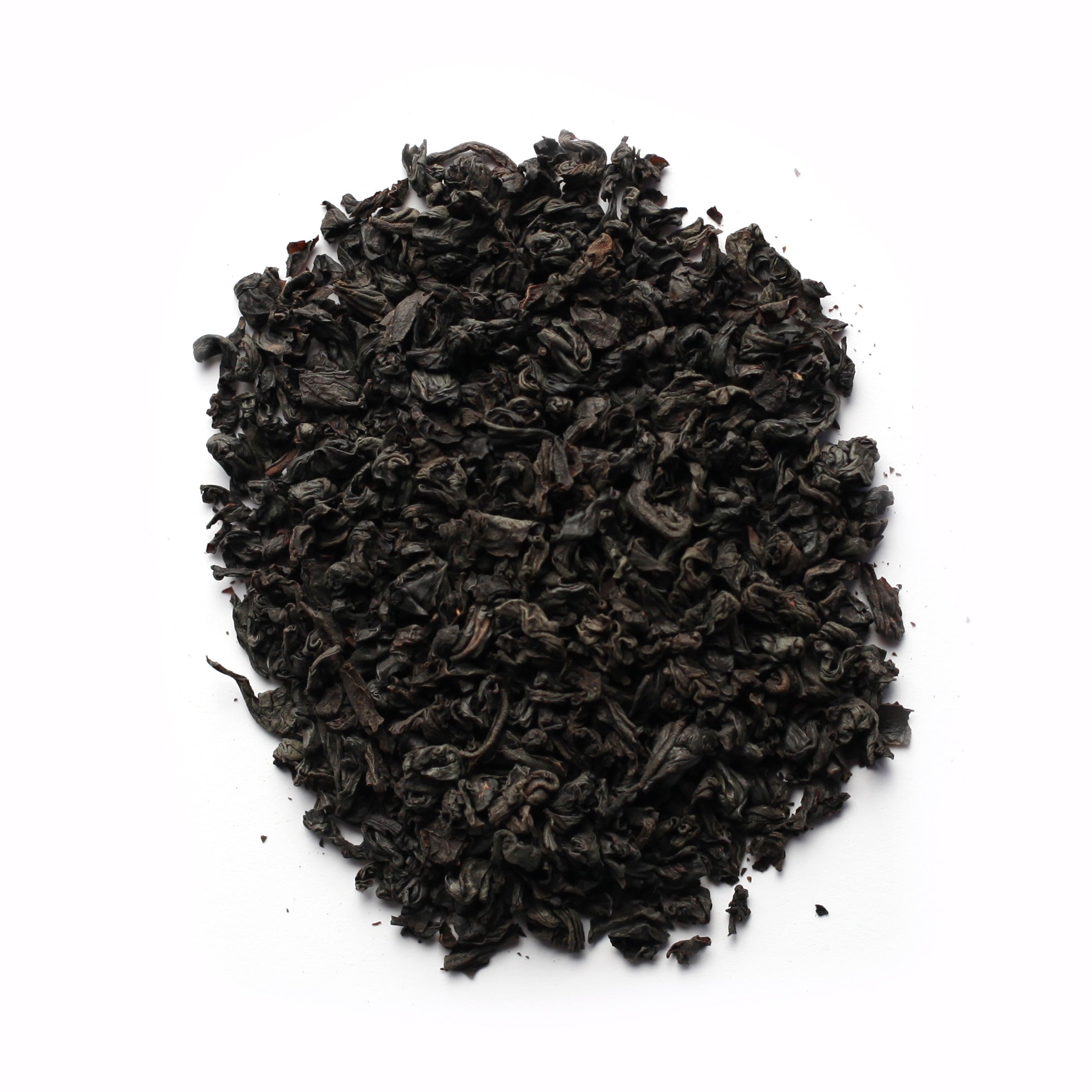 A close-up of black tea leaves on a white background.