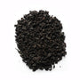 A close-up of black tea leaves on a white background.