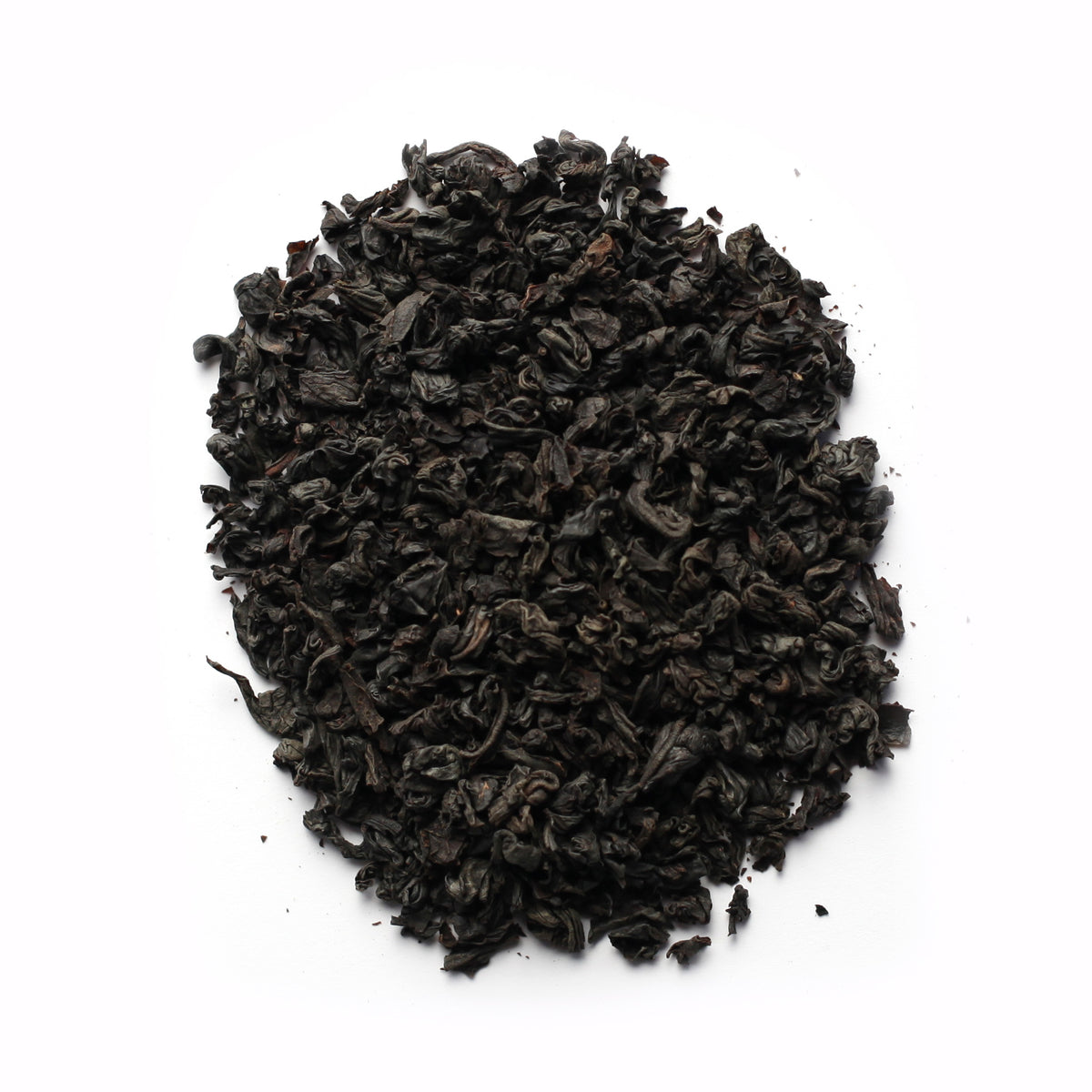A close-up of black tea leaves on a white background.