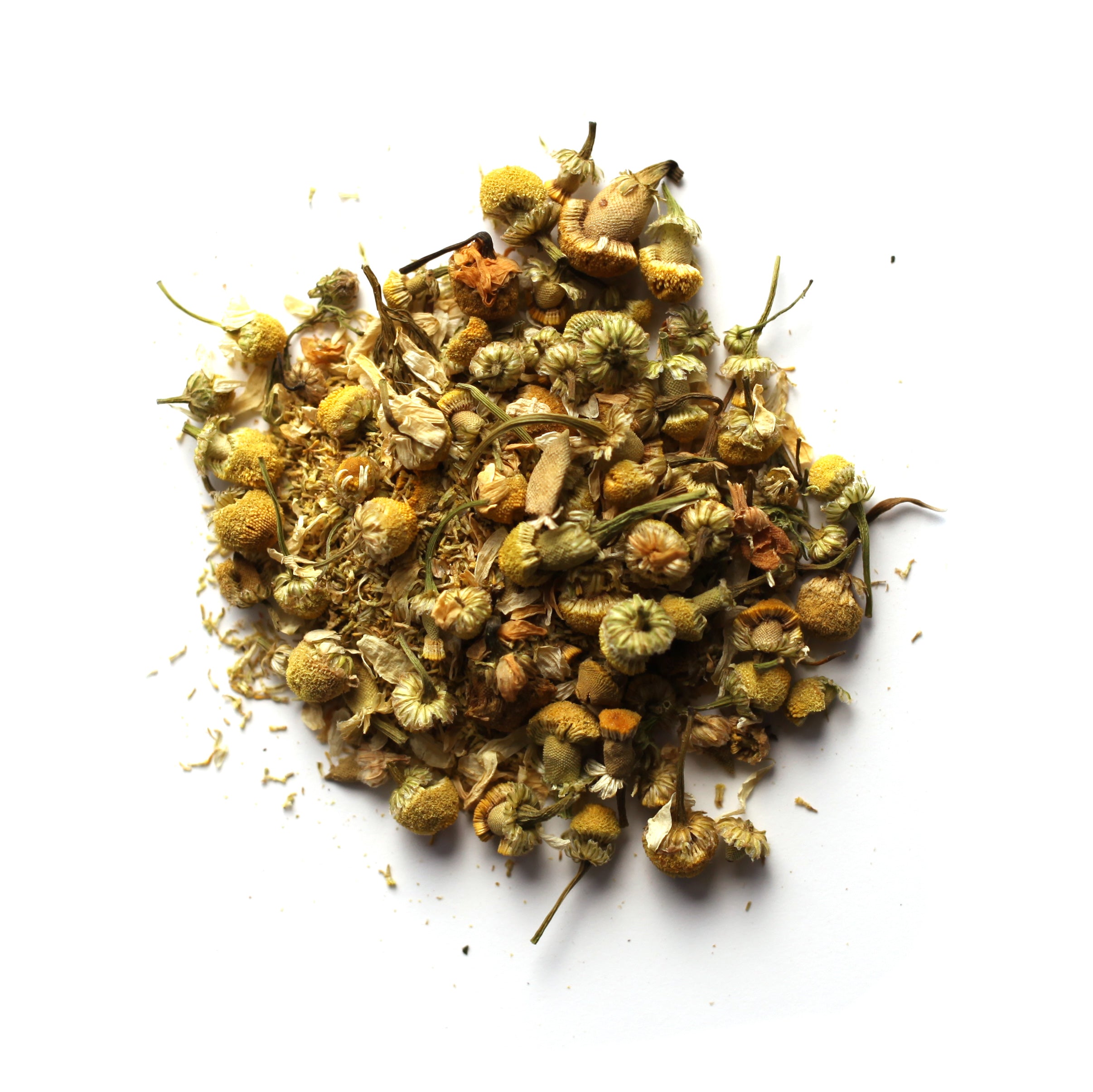 A pile of dried chamomile flowers, with a mix of yellow and green hues, on a white background.