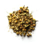 A pile of dried chamomile flowers, with a mix of yellow and green hues, on a white background.