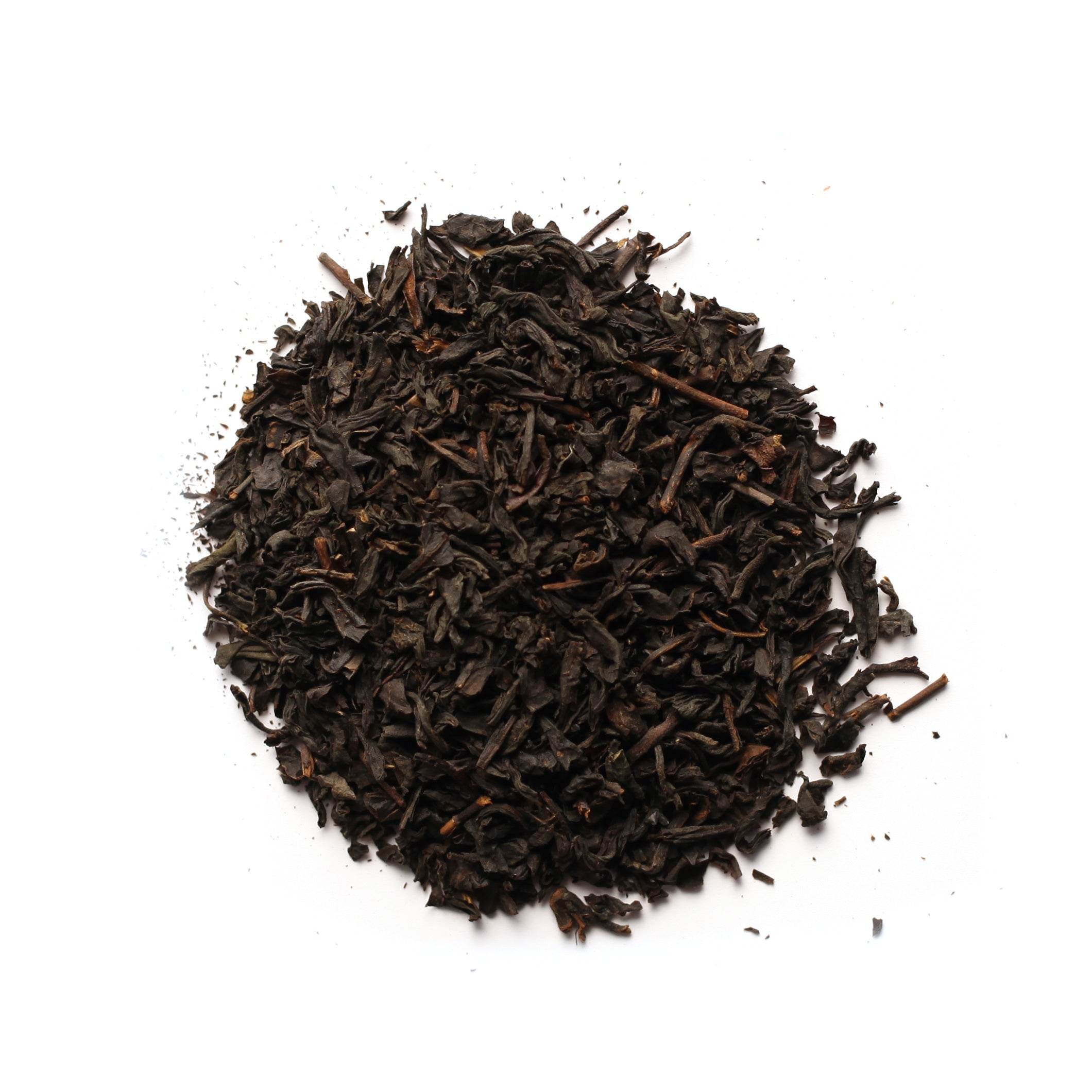 A pile of black tea leaves with hints of orange zest, indicative of the Black Earl Grey tea blend.