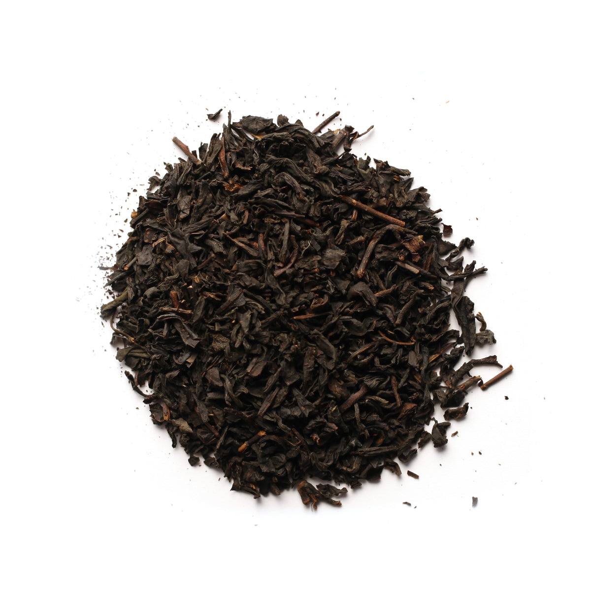 A pile of black tea leaves with hints of orange zest, indicative of the Black Earl Grey tea blend.